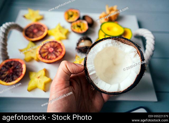 Exotic fruits on a tray on a light background