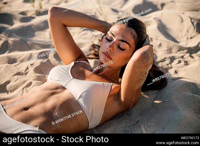 young woman, sunbathing, sandy, beach holiday