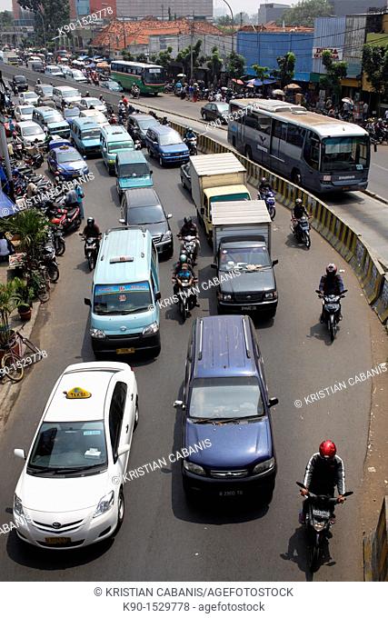 View from above with traffic jam on Jalan Matraman with mini busses and a bus on a separated buslane, Jakarta, Java, Indonesia, Southeast Asia