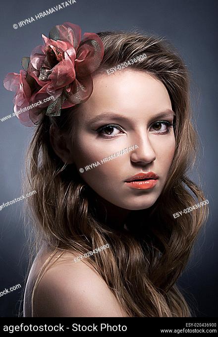 Art portrait of young attractive girl with bow close up