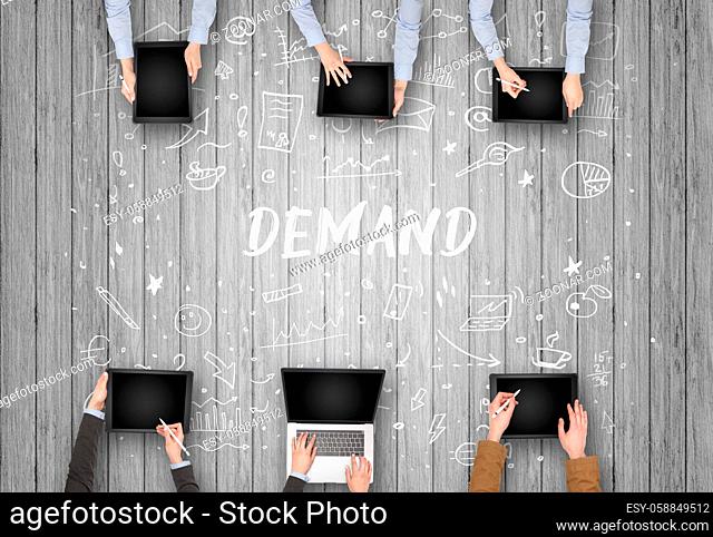 Group of business people working in office with DEMAND inscription, coworking concept