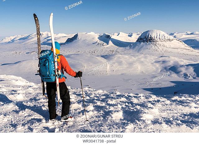 skier watching mountains in Sarek NP, world heritage Laponia, Lapland, Sweden