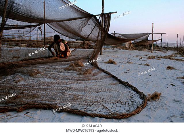 A fisherman weaving a net, at Shoronkhola Khulna, Bangladesh January 1, 2008