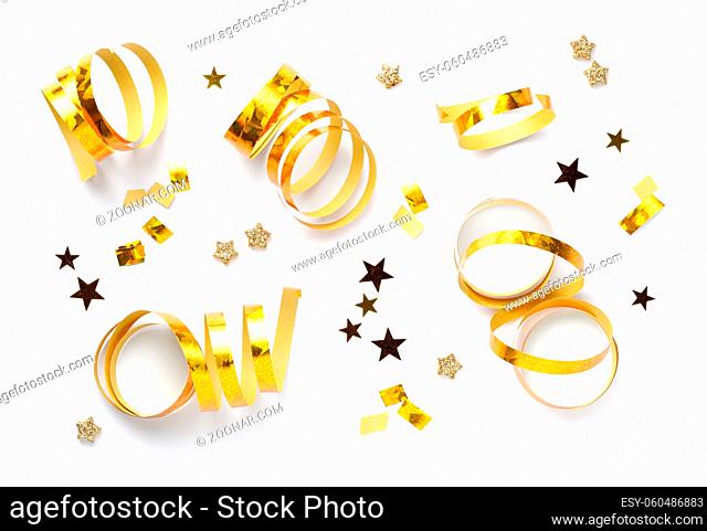 Curly gold serpentines and golden stars isolated on white background. Christmas, holiday decoration. Top view