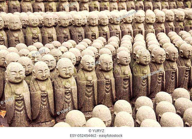 rows of similar Japanese Jiizo sculptures; focus on central part