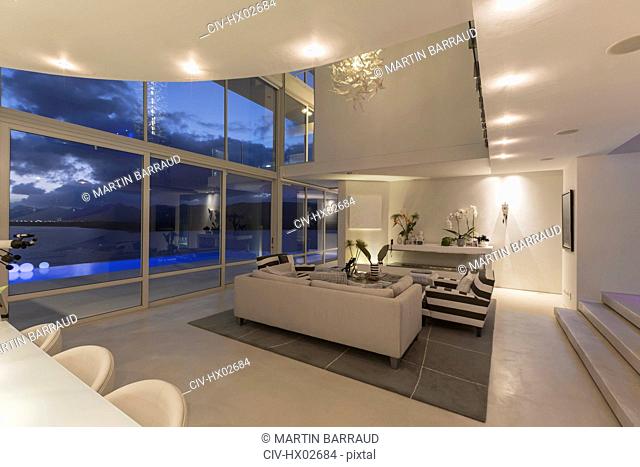 Illuminated modern luxury home showcase interior at night