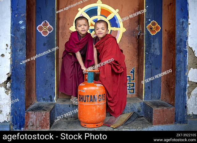 Funny monks with a butane gas bottle in Gangtey Monastery, Phobjikha Valley, Western Bhutan, Asia