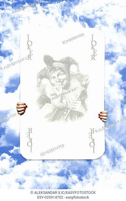 Joker Playing Card On A Cloudy Sky Background
