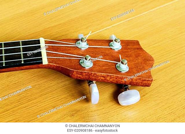 ukulele on wood background