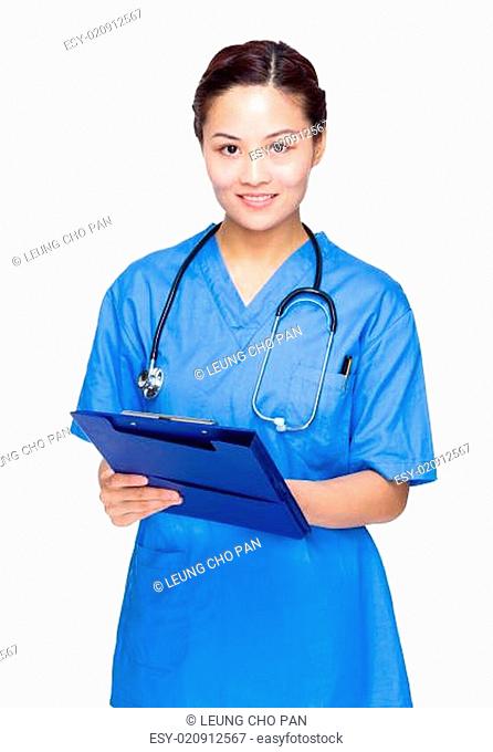Asian female doctor write on clipboard