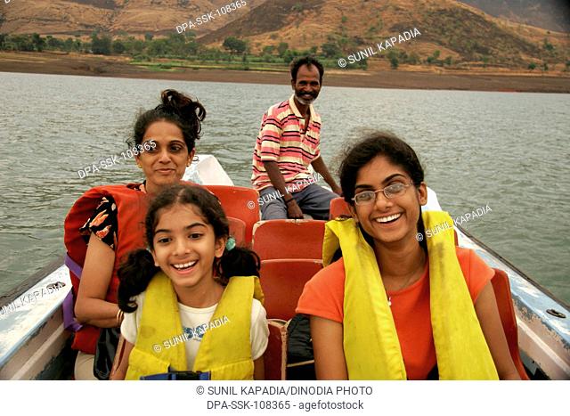 South Asian Indian mother with daughters wearing life-jackets enjoying motor boat ride at Dhom dam ; Wai ; Maharashtra ; India MR191;645;189