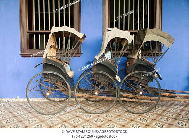 bicycle rickshaws in front of the Cheong Fatt Tze Chinese Mansion in Georgetown, Malaysia