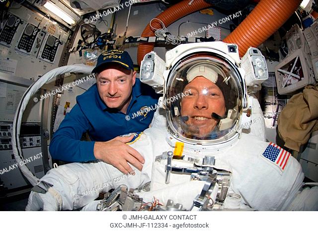 A fish-eye lens on a digital still camera was used to record this image of astronauts Mark Kelly (left) and Mike Fossum, STS-124 commander and mission...
