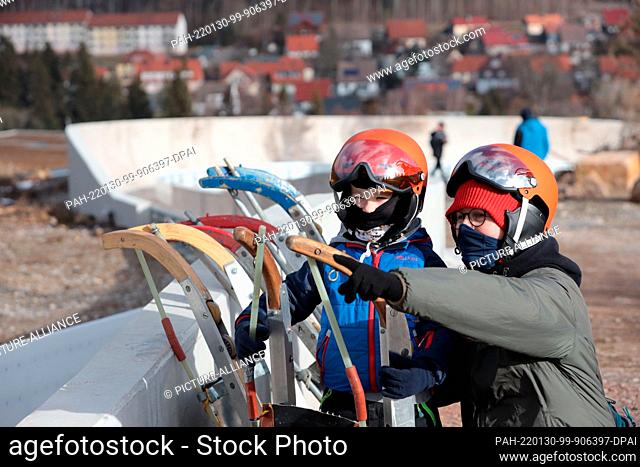 30 January 2022, Saxony-Anhalt, Schierke: Visitors stand during a trial sledding event at the new luge track in Schierke