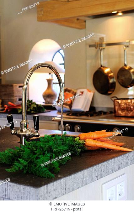 Carrots next to kitchen sink
