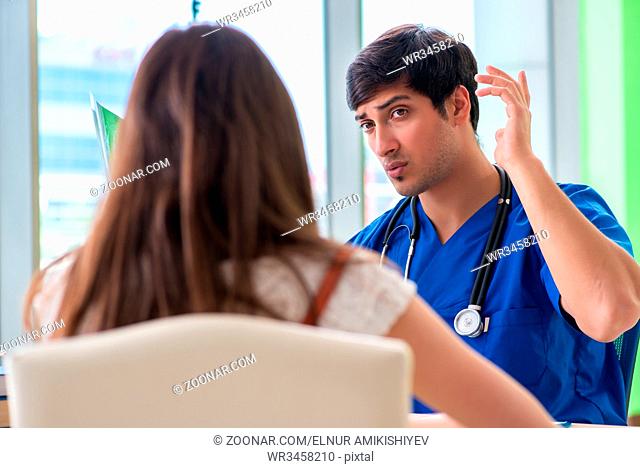 Female patient visiting male doctor in medical concept