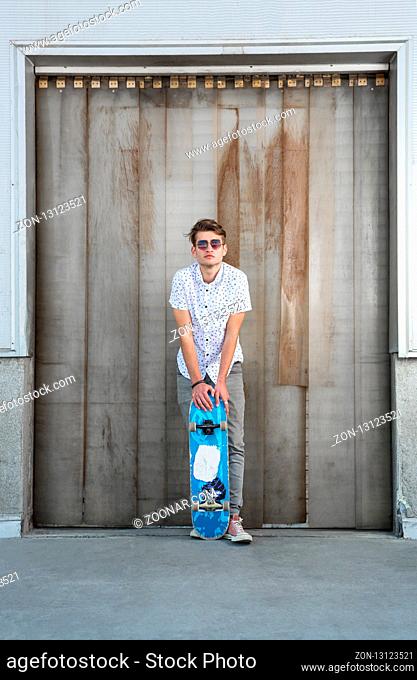 Young man and skateboard on the city street