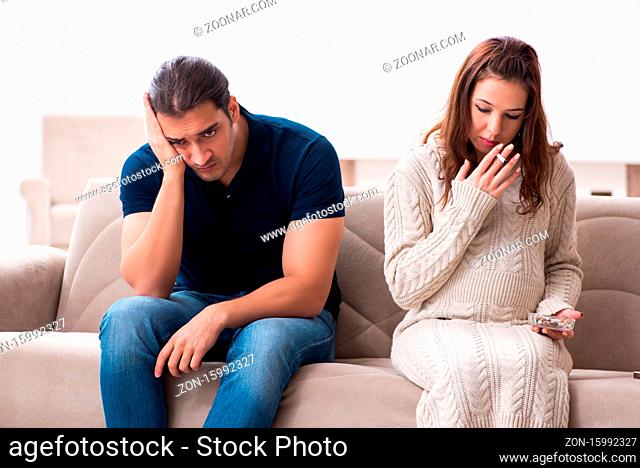 Man and pregnant woman in the antismoking concept