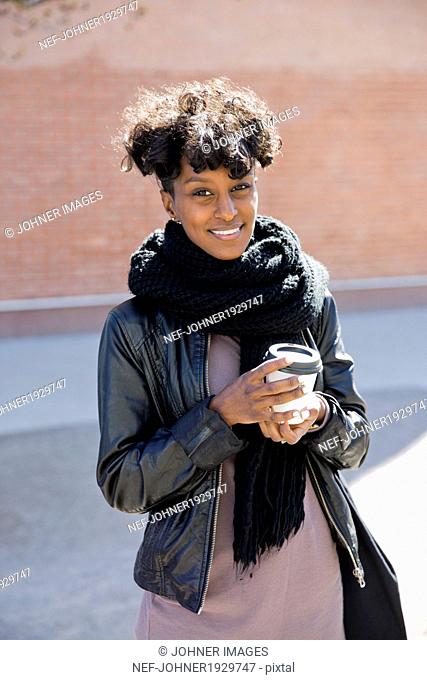 Happy young woman with coffee