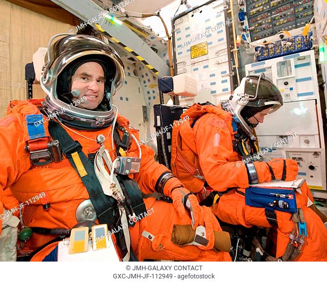 NASA astronauts Greg Chamitoff (left) and Andrew Feustel, both STS-134 mission specialists, attired in training versions of their shuttle launch and entry suits