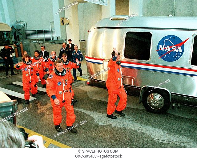 01/31/2000 --- The STS-99 crew wave to onlookers as they walk to the astrovan which will take them to Launch Pad 39A and liftoff of Space Shuttle Endeavour