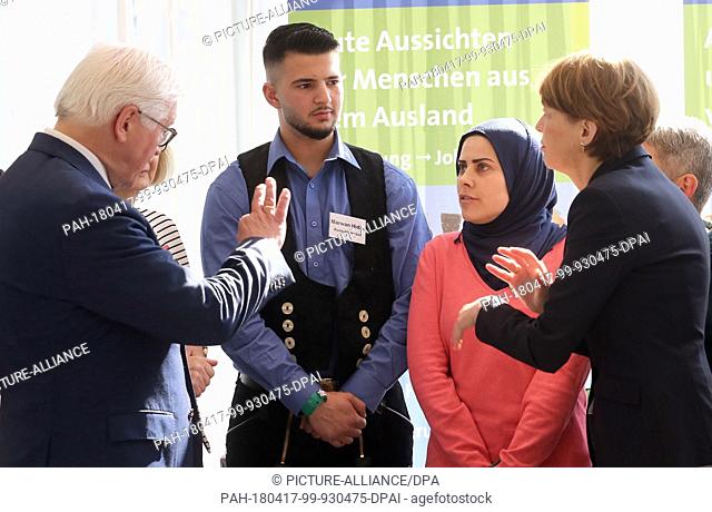 17 April 2018, Berlin, Germany: German President Frank-Walter Steinmeier (L) and his wife Elke Buedenbender (R) talk to trainees Kawthar Khalil (2-R) and Marwan...