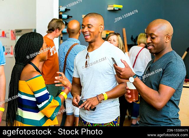 Johannesburg, South Africa - October 15 2016: African Friends eating, drinking and generally enjoying a day out at a Food and Wine Fair