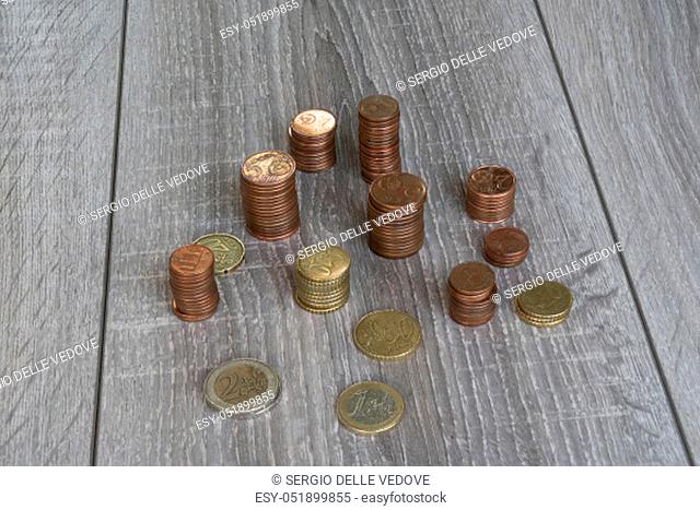 Udine, Italy, July 17, 2019. some stacks of euro coins on a wooden table