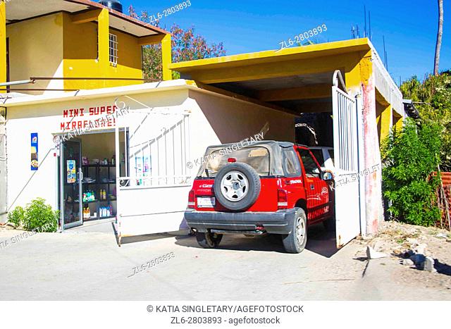 Mini tiny supermarket called' mini Miraflores' set under a yellow house in the middle of nowhere outside of Cabo San Lucas