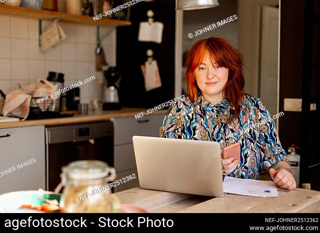 Smiling woman holding cell phone