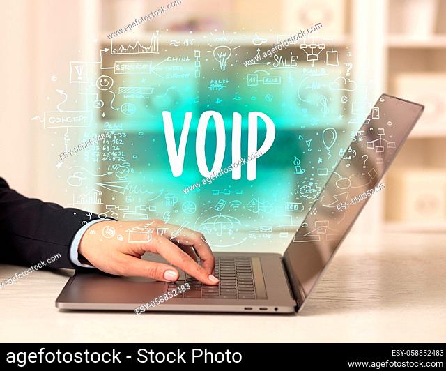 hand working on new modern computer with VOIP abbreviation, modern technology concept