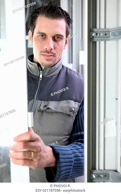 Worker installing a door