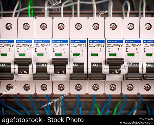 Electric switches in fusebox. Many black circuit brakers in a row. 3d illustration