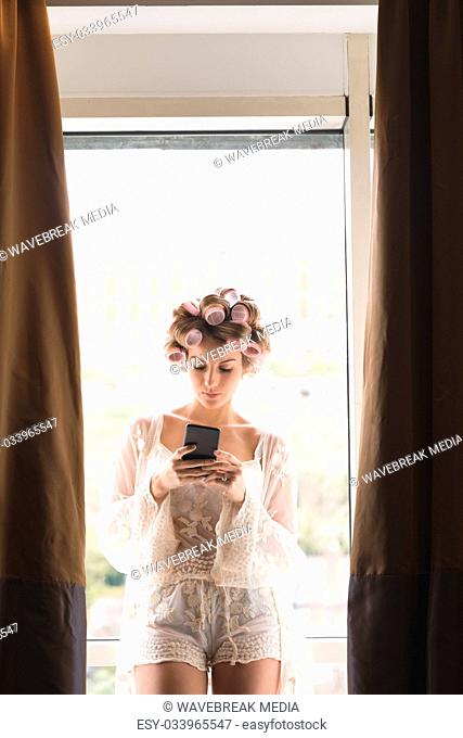 Young bride using mobile phone