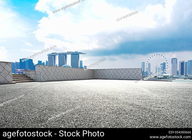 empty asphalt road and cityscape of singapore in cloud sky