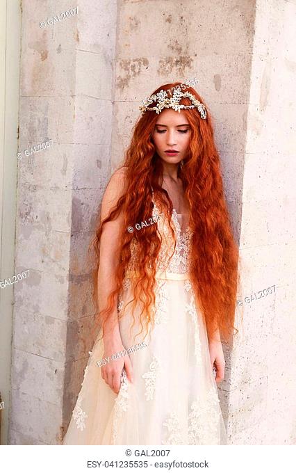 Beautiful red-haired girl with long curly hair in the bride, in a long lace  dress, Stock Photo, Picture And Low Budget Royalty Free Image. Pic.  ESY-041235535 | agefotostock