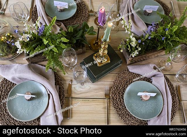 High angle close up of rustic place setting for a woodland naming ceremony