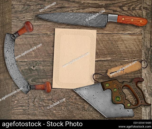 vintage kitchen knives and utensils over wooden board board, blank card for your text