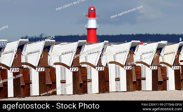 11 April 2023, Mecklenburg-Western Pomerania, Warnemünde: First beach chairs stand on the Baltic Sea beach. Cool and changeable April weather dominates in the...