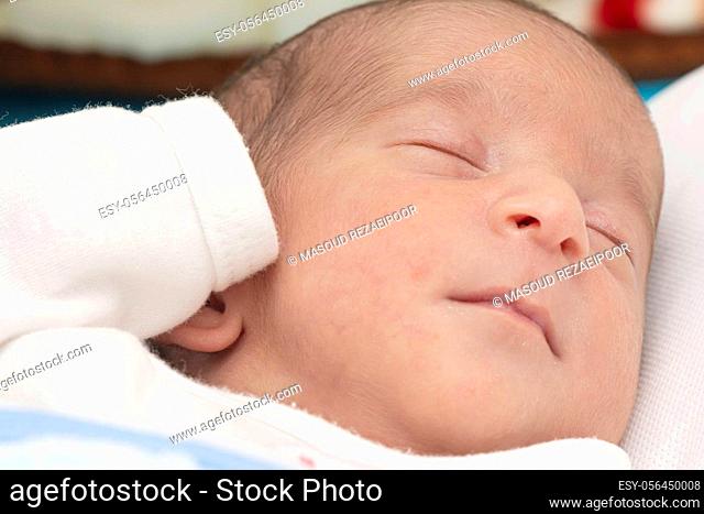 Closeup portrait of a newborn baby peacefully slept in bed