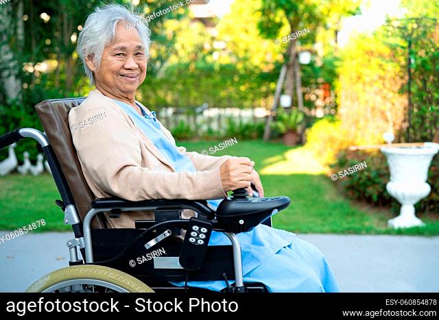 Asian senior or elderly old lady woman patient on electric wheelchair with remote control at nursing hospital ward, healthy strong medical concept