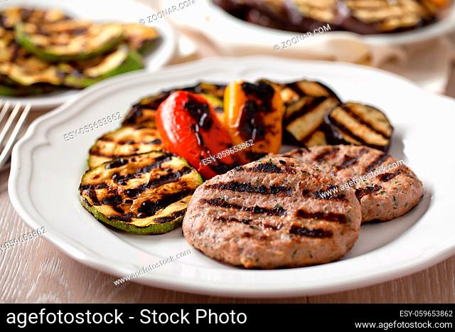 Hamburger with grilled mixed vegetables on a plate