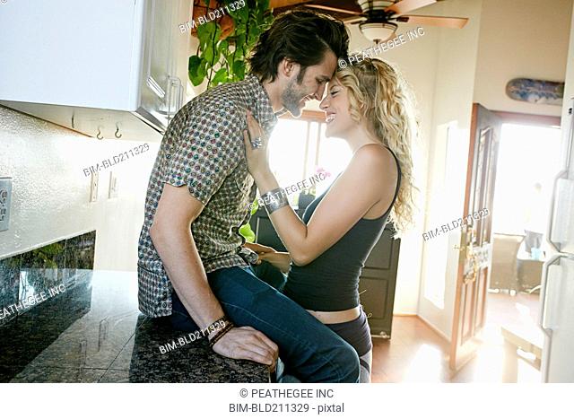 Couple hugging in kitchen