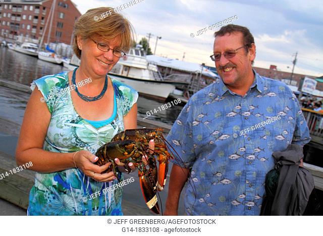 Maine, Portland, Historic Old Port District, Long Wharf, Lucky Catch Cruises, lobstering excursion, woman, man, couple, holding, lobster