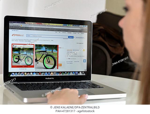 ILLUSTRATION - A young woman browses on her notebook computer through the web page of Chinese online retailer Alibaba looking at bicycles on sale in Berlin