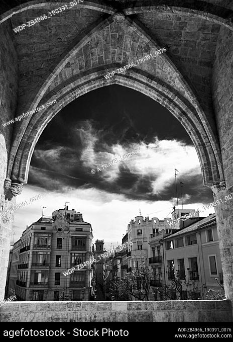 A gothic window opens into the old section of Valencia in Spain