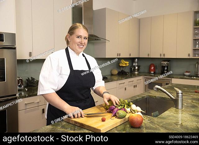 Portrait of Chef Megan Gill in home kitchen looking at camera smiling with pride