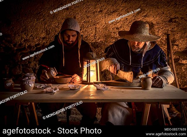 Middle Ages - second half of 14th Century. Hypothetical reenactment of Northern Italy customs and traditions. Winter, house interior: preparing the spices for...