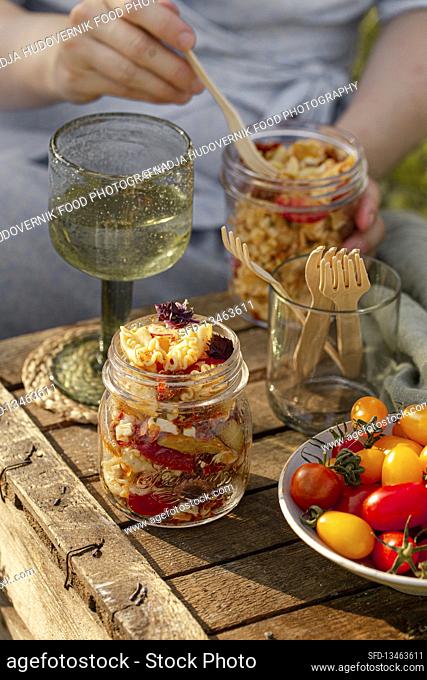 Pasta salad in glasses for picnic