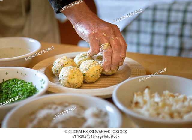 a chef has finished some of homemade dumplings, (canederli), Bolzano province, South Tyrol, Trentino Alto Adige, Italy,